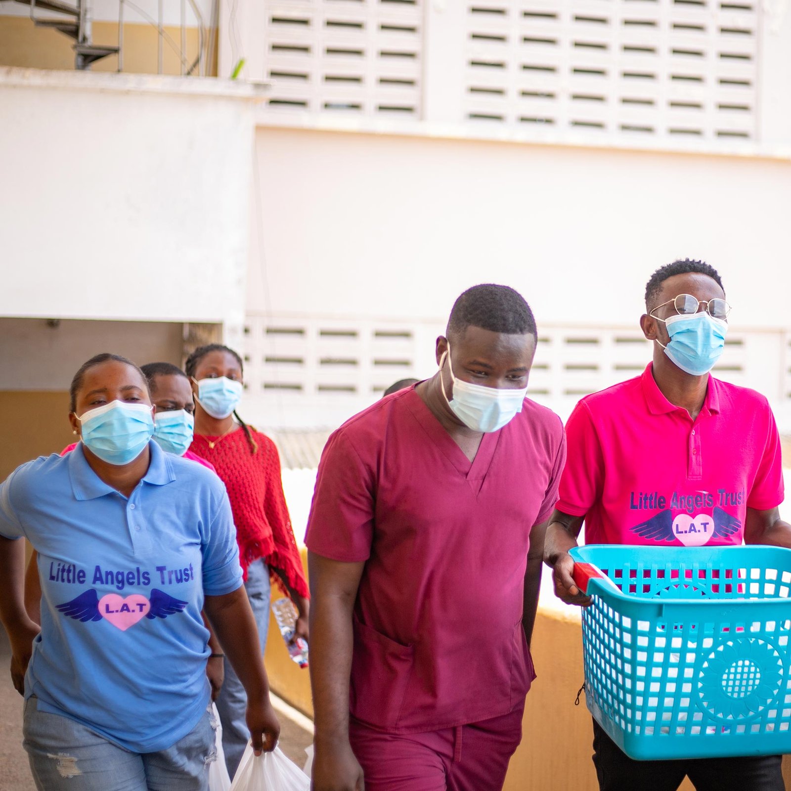 A member of the Little Angels Team presenting a gift to a patient during our easter visitation